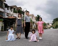 Third Sister's Fourth Son with Wife and three Daughters outside their suburban home, Kuala Lumpur